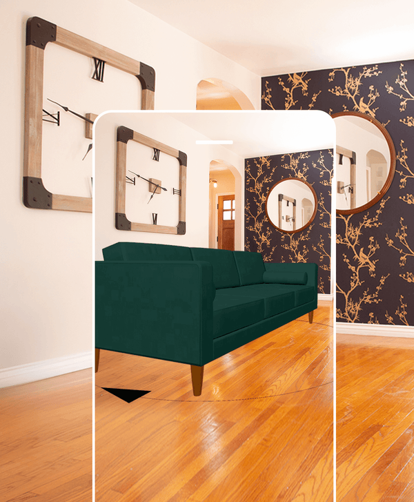 Phone screen showing a virtual image of a dark green couch in a room with wooden floors.