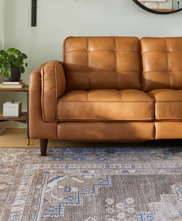Modern Tufted Camel Colored Leather Sofa on a Multi-Colored Rug