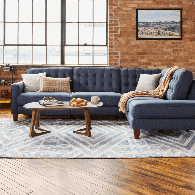 Blue sectional on a brick background